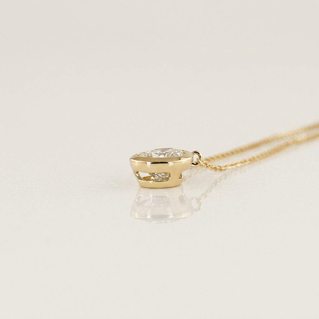 1.00 CTW BEZEL PEAR PENDANT